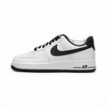 White and black Nike sneaker, side view on a white background